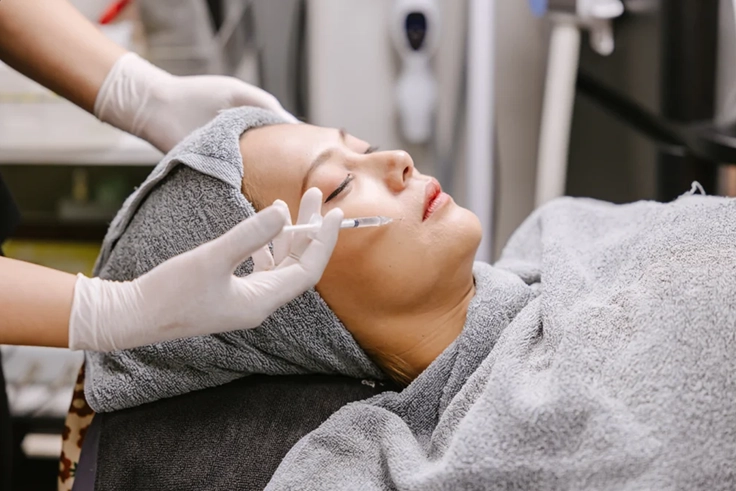 Glutathione Injection Treatment for Healthy Glowing Skin Woman receiving glutathione injection for skin brightening, anti-aging, and overall health benefits
