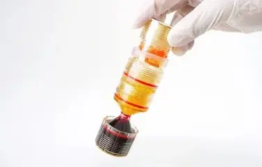 A person wearing white gloves is carrying a tube filled with liquid, like medicine or chemicals.