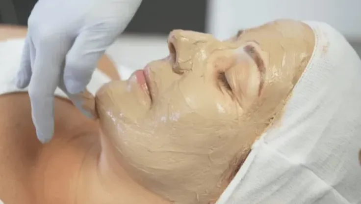 Best Cosmelan Depigmentation Skin Treatment in Coimbatore A woman had a facial mask applied during a cosmelan depigmentation skin treatment at a spa
