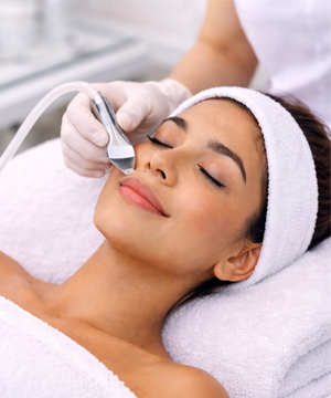 Exfoliation step removing dead skin cells to improve texture and clarity under expert care
